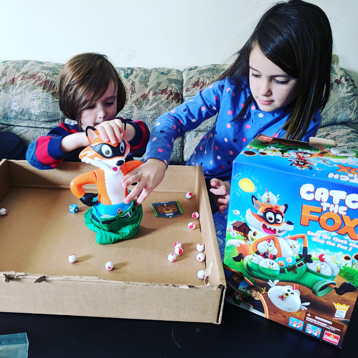Kids playing Catch the Fox board game together