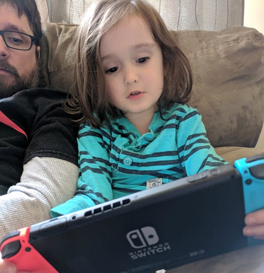 Brian and Xander looking at Nintendo Switch