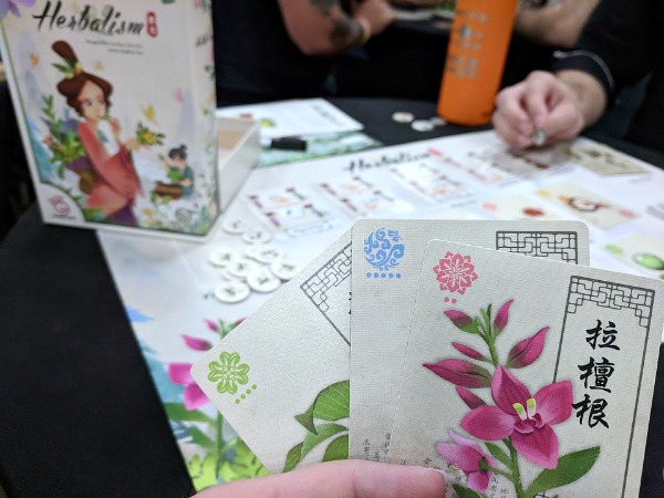 Playing demo of Herbalism game at Origins Game Fair