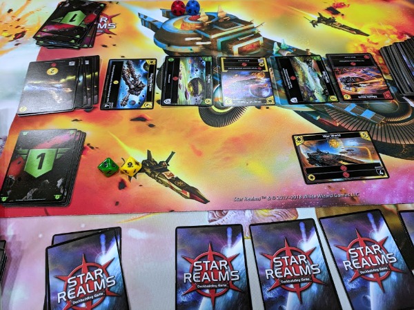 Star Realms deck building game set up with game mat.